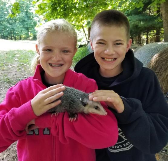 Allison Freeland and Will Denny hold a small animal in this photo from several years ago