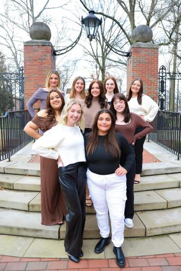 The members of the 2024 Panhellenic Council Executive Board stand in front of the College Gate