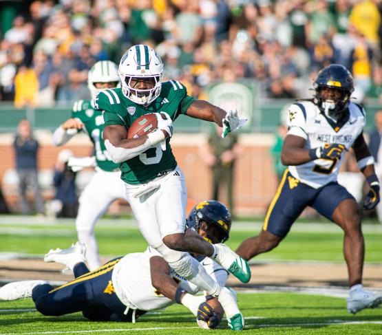 An OHIO Football player runs with the ball against  West Virginia University in Peden Stadium