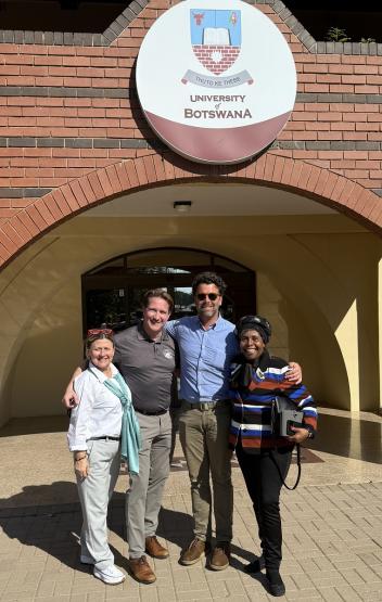 Representatives of Ohio University and the University of Botswana stand together outside of a University of Botswana sign