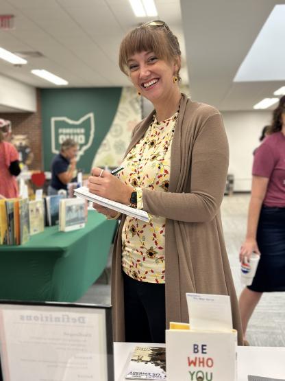 An individual looks at a book at the 2024 Banned Book Cafe at Ohio University Zanesville