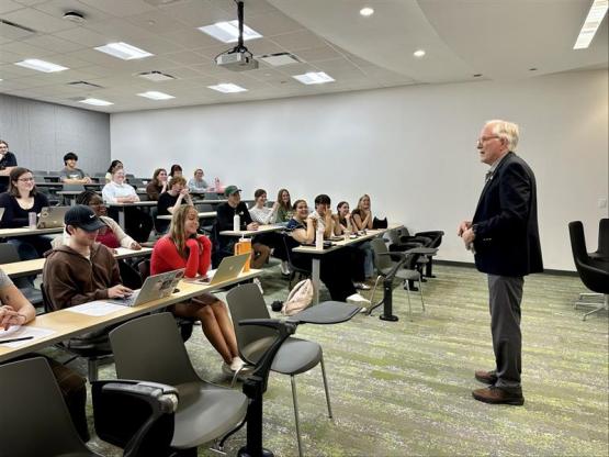 David Krane speaks to a classroom full of students