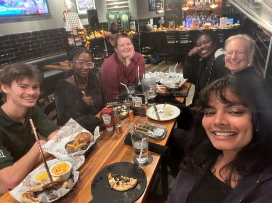 OHIO students and alumni sit together and eat dinner