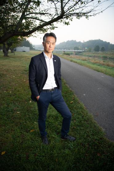 Dr. Yutaka Hirata is  shown standing near the bike path and Hocking River on the Ohio University campus
