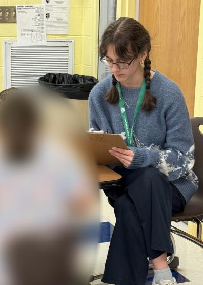 An OHIO student works on a project while sitting at a table at Zane Grey Elementary School