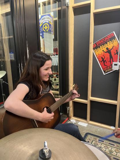 Julia Porter playing along as a child played drums
