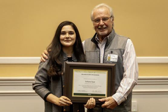 John Kopchick and Sohana Siyar hold the award