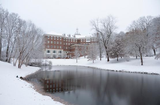 Baker University Center and the pond in front of it are shown on snowy day at Ohio University