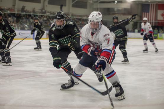 OHIO Hockey players surround an opposing player during a game at Bird Arena that took place over Sibs Weekend 2025.
