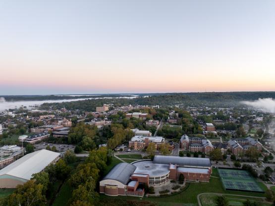 An aerial image of the Ping Center, tennis courts, Walter Fieldhouse and much of the OHIO campus at sunrise