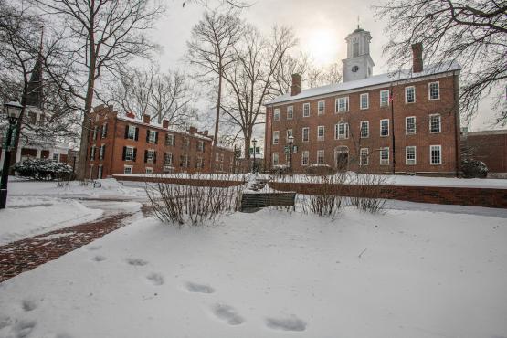 Cutler Hall and the College Green are covered in snow while the sun shines over Cutler Hall