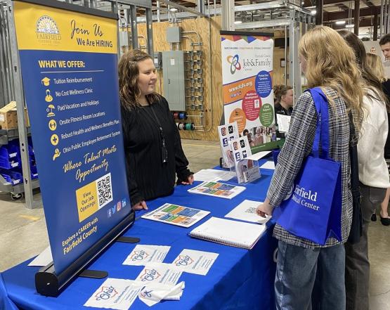 OHIO students talk to a representative at a job fair booth