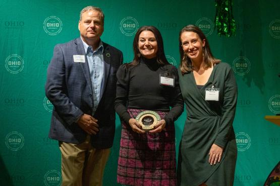 OHIO representatives  stand with Rebecca Robison-Miller, who is holding her award