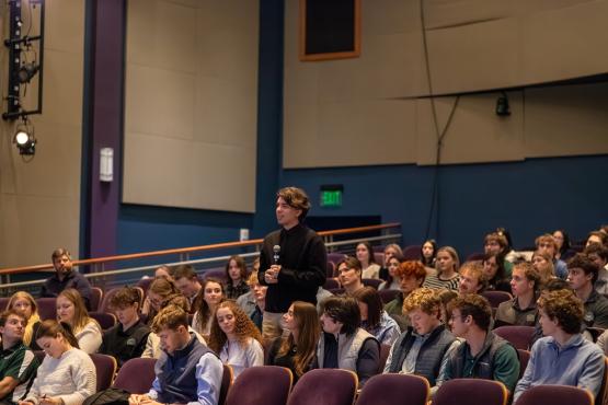 An audience member stands  up and asks a question at the Lead Live event.