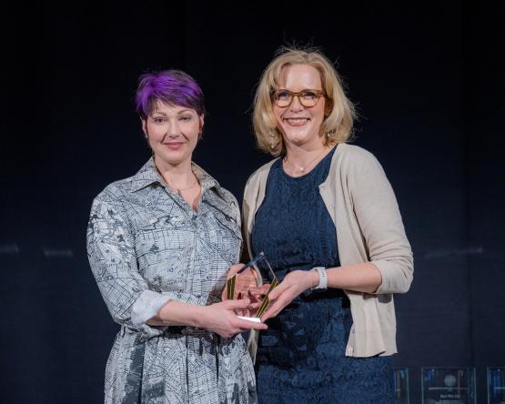 Beth Quitslund and Rebekah Crawford hold the award