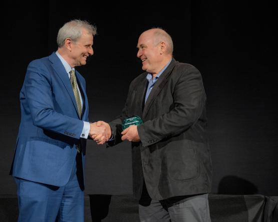 Provost Don Leo and Geoff Dabelko shake hands