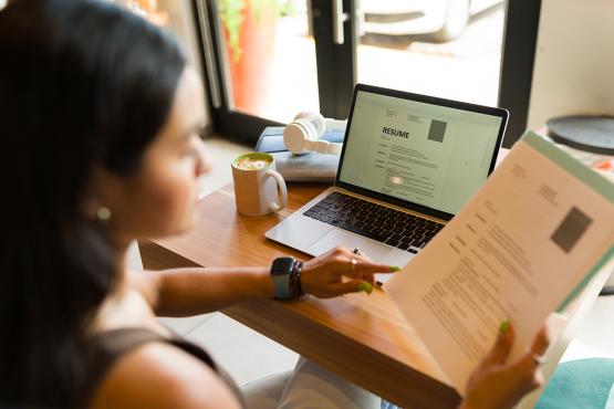 A woman searches for a job using her laptop