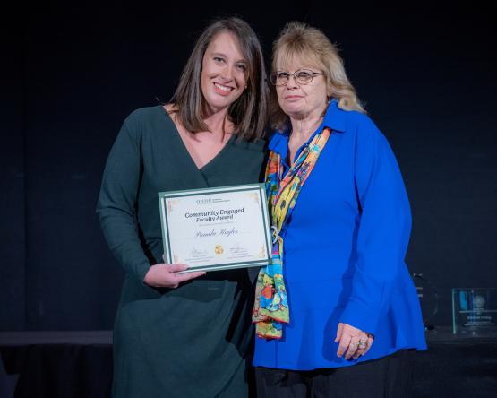 Courtney Lefebvre stands with Pamela Kaylor and holds the award certificate that Kaylor received