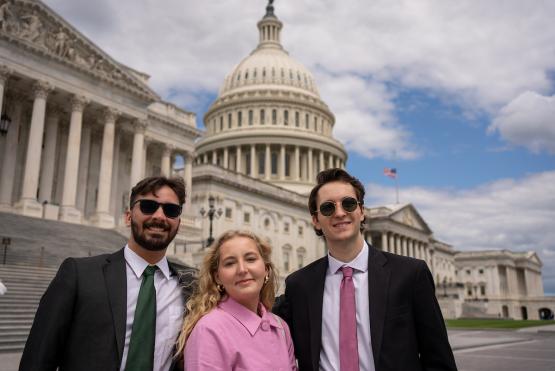 Three OHIO students are shownin front of a federal government buildingin Washington, DC