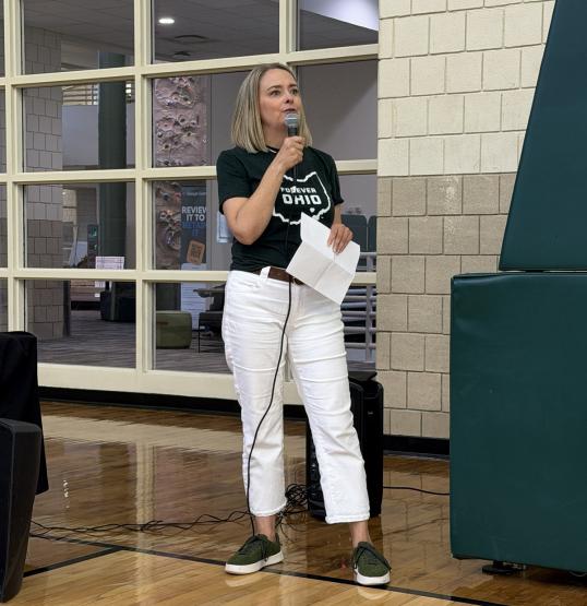 Kathy Fahl speaks into a microphone during the event