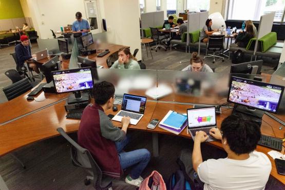 OHIO students study and conduct research while sitting at desks and tables and working on computers in Alden Library