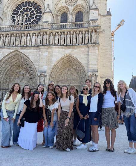 OHIO students and faculty stand  together for a photo while outside in Paris