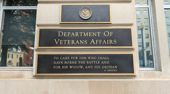 The outside of the Department of Veterans Affairs building, showing a plaque that says "Department of Veteran Affairs - To care for him who shall have borne the battle and for his widow, and his orphan - A. Lincoln"