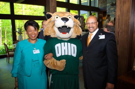 Hon. Yvette McGee Brown stands with her husband Anthony Brown and Rufus the Bobcat.