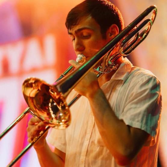 Andrew "AJ" Gacnik plays a musical instrument while in Thailand