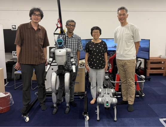 OHIO and Chubu University representatives stand together in a lab that has robotic equpiment in it at Chubu University