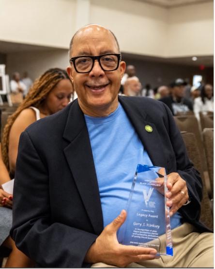 Gary Kirksey holding the award he earned from the NABJ. 
