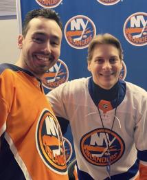 Two men pose for a photograph in New York Islanders t-shirts