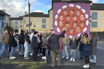Student group in front of a mural in Northern Ireland