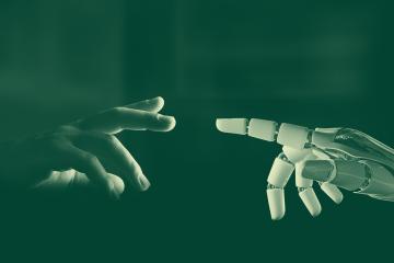 A human hand reaching out to touch a robot hand.