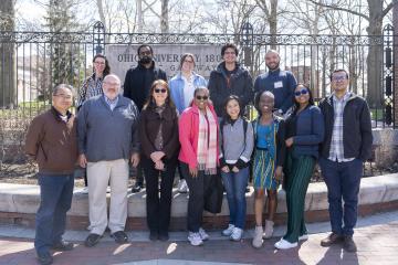 The Hubert H. Humphrey Fellows and several OHIO  representatives pose for a photo at the College Gate