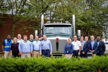 Representatives of Ohio University and Kenworth stand in front of a truck outside of the Chillicothe plant