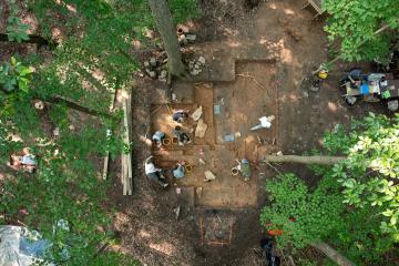 An overhead view of people digging in an archeological site