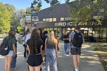 A Learning Community Leader shows first-year students the Bird Ice Arena