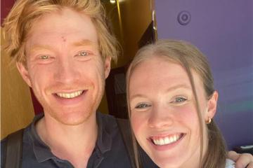 Two people pose for a selfie