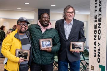 Three recipients of the Scripps College Pillar Awards hold their awards at Ohio University
