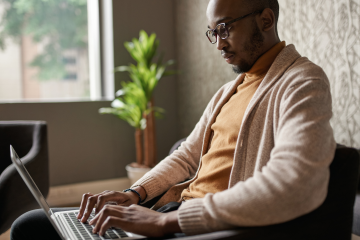 professional working in office typing on computer