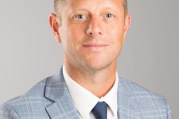 A professional headshot of Dustin Kilgour. 