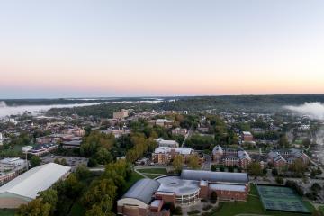 An aerial image of the Ping Center, tennis courts, Walter Fieldhouse and much of the OHIO campus at sunrise