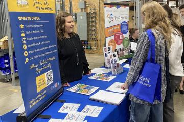 OHIO students talk to a representative at a job fair booth
