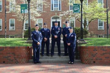 Members of the Ohio University Air Force ROTC stand in their uniforms in front  of Cutler Hall