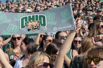 Students hold up an Ohio University sign during a football game. 