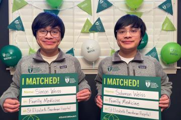 Solomon and Simon Weiss holding Match Day signs