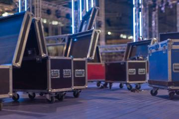 flight cases lined up on a stage in preparation for a live concert