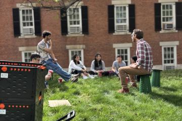 An  OHIO faculty member leads a class  outside, while the Outdoor Class Kit container is nearby