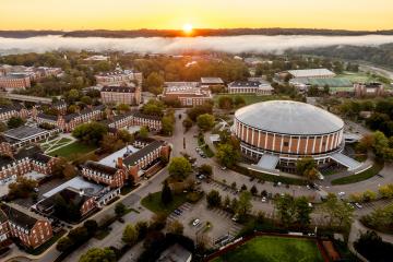The Convocation Center and West Green are shown in this aerial photo, in the background, there is fog over the Hocking River